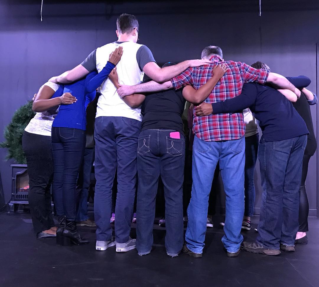 Workshop participants in a team huddle
